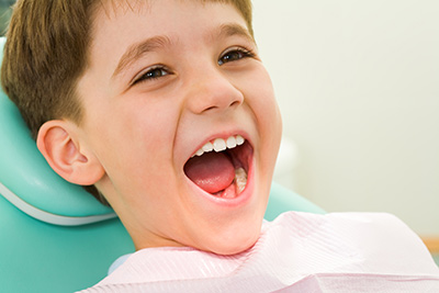 kid smiling while in the dental chair