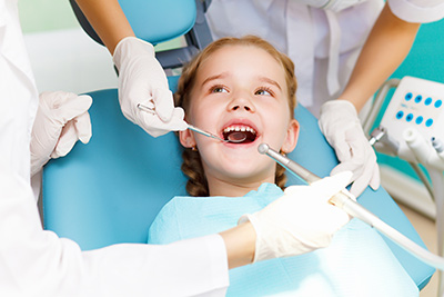 child smiling during a dental procedure