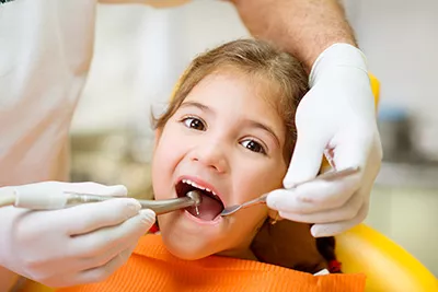 child getting her teeth looked at during a visit to Bishop Arts Kids Dentistry