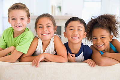 child smiling with her friends after getting her teeth whitened at Bishop Arts Kids